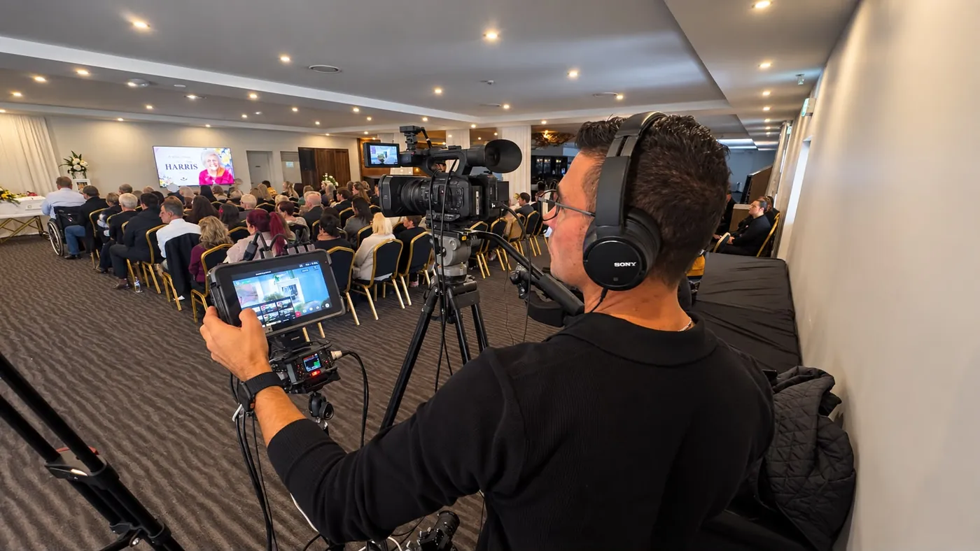 Warren Bonello of EVP Films filming a Harmony Funerals service